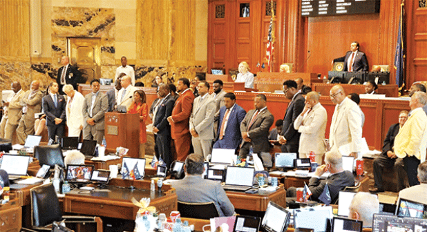 Democratic lawmakers stand together Monday in the Louisiana House of Representatives to oppose Rep. Emily Chenevert’s House Bill 685, which prohibits policy on diversity, equity and inclusion in state government and prevents state colleges and universities from requiring DEI in their curricula with limited exceptions. (Wes Muller/Louisiana Illuminator)