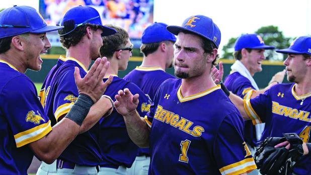 Aidan Mouton (center) celebrates winning the South District Series Championship with Tyler Mitchell (left) and teammates. (Photo by Travis Webb)