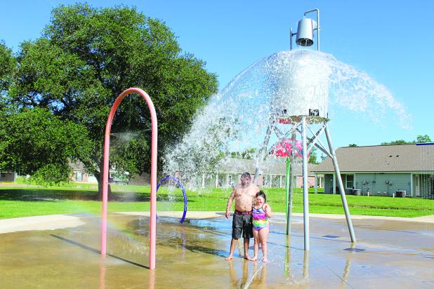 According to the calendar, Summer officially begins June 20. However, in Eunice, Summer temperatures has already began. The Splash Pad at the Fairgrounds is officially opened to the public. On Tuesday afternoon Ed and Adelyna Ramirez, 7, were enjoying cool splashing water fun. (Photo by Myra Miller)