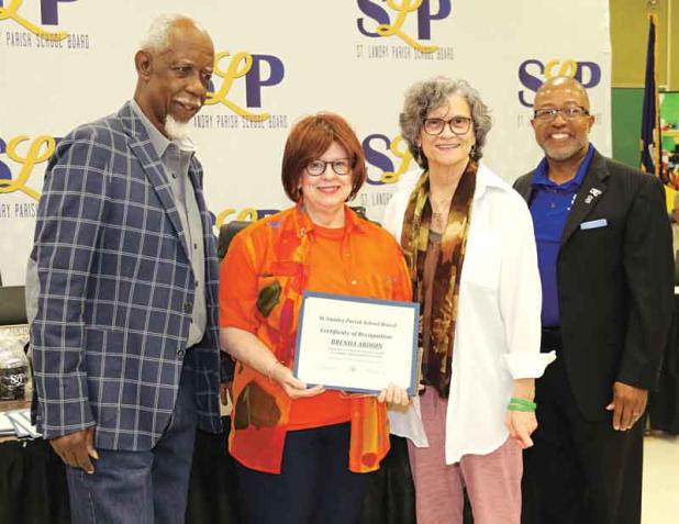 The St. Landry Parish School Board recognized retirees at its Thursday meeting. From left, are Albert Hayes Jr, Board presidnet; Brenda Ardoin, retired from Eunice High as a teacher with 34 years of service; Mary Ellen Donatto, Board member; and Patrick Jenkins, school superintendent. Eighteen retirees were recognized. (Photos by Harlan Kirgan)