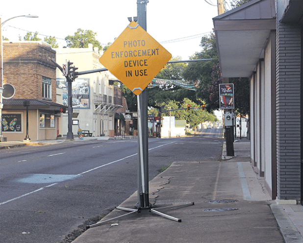 A sign on East Landry Street in Opelousas near the St. Landry Parish Courthouse warns of photo enforcement of the speed limit. Rep. Dustin Miller, of Opelousas, acted to exempt the Opelousas traffic cameras from a state law banning them. (Photo by Harlan Kirgan)