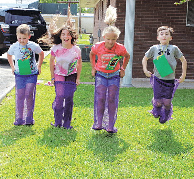 And they are off to the finish line at Happy Days Vacation Bible School at St. Anthony’s Church. The Jeanmard Center was the place to be for children kindergarten through fifth-grade ages. The theme of the Happy Days was, “Stellar Shine Jesus’ Light.” Enjoying a sack race, from left, are Gus Thibodeaux, Raphaela High, Rose Cleland and Jack Turner. (Photo by Myra Miller) 