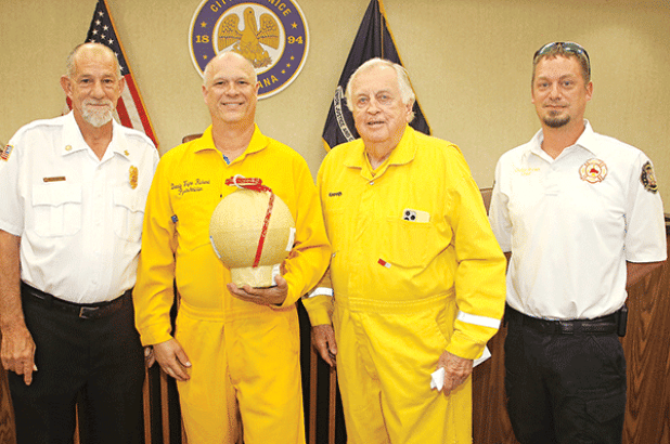 Fireworks were discussed at Tuesday’s Eunice Board of Aldermen’s meeting. Former Mayor Kenneth Peart, third from left, said he is stepping back from his role as the lead in staging the Fourth of July show at the Recreation Complex. From left, are Acadia Parish Fire District 4 Chief Harral “New York” Johnson; Donald Richard, who is taking the lead for the fireworks show and holding an aerial shell; Peart; and Eunice Fire Chief Chaise Brown. (Photo by Harlan Kirgan)