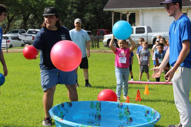 Avi Pitre gives it a try during an outdoor activity at First Baptist Church's Vacation Bible School.