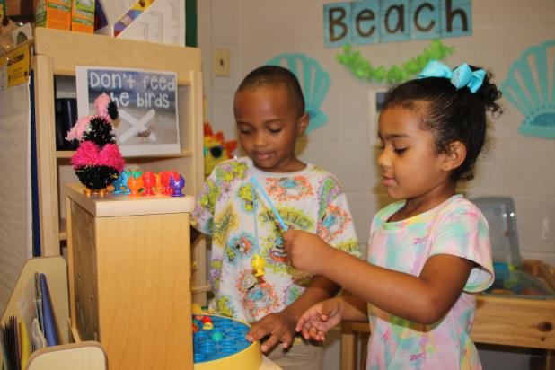 Fishing next to a beach at Highland Early Learning Center are Markel Henry Jr. and Aizilyn Kennedy. Four year old pre-k students attended a Summer Prep Camp  for Kindergarten at Highland and visited learning centers where they pretended to be at beach. (Photos by Myra Miller)