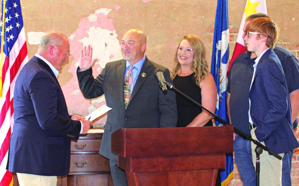 From left, are Judge David Smith, Sheriff KP Gibson, Monica Gibson, Cameron Gibson (back), and Carter Gibson (front). (Submitted photo)