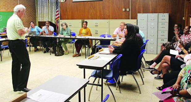 Demographer Mike Hefner, left, speaks at a St. Landry Parish School Board Committee of the Whole meeting on Tuesday in Opelousas. The Board is considering a new enrollment projection plan. (Photo by Harlan Kirgan)