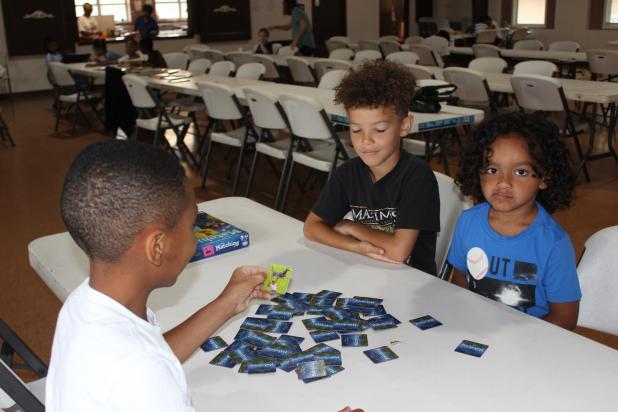 Playing a memory matching game are Leo Sam, Dawson Reed and Easton Celestine at the Kids Summer Camp held at the Southeast Center.