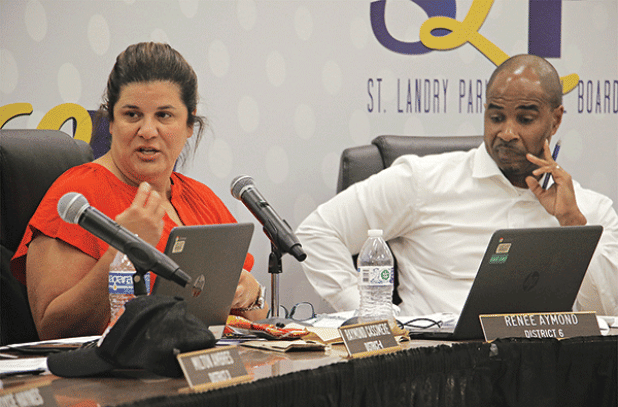 St. Landry Parish School Board member Renee Aymond and Superintendent Milton Batiste III at Tuesday’s Board meeting. Aymond is discussing a $1,000 across-the-board pay raise for employees. (Photo by Harlan Kirgan)