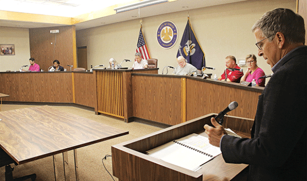 Steve Moosa, right, CPA with Darnall Sikes & Frederick, reads highlights from the city budget at a special meeting on Wednesday. Seated, from left, are Chad Andrepont, Ward 1 alderman; Germaine Simpson, Ward 2 alderwoman; Ginny Moody, city clerk; Scott Fontenot, mayor; Marion “Nootsie” Sattler, alderman at-large; Randall Reed, Ward 3 alderman; and Connie Thibodeaux, Ward 4 alderwoman. (Photo by Harlan Kirgan)