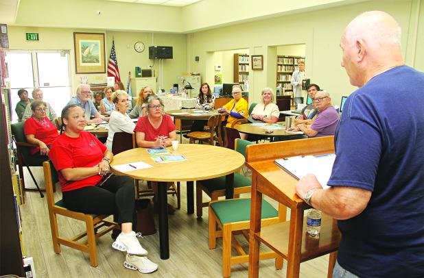 Tony Baltakis, right, president of the Eunice Library Board of Control, beings a meeting to organize a Eunice Friends of the Library on Thursday. The group is formed to become a fundraising arm of the library. The meeting also included electing officers. They are, in the photo at right, and from left, April DeRouen, vice president; Kyle Huval, president; Patina Mitchell, treasurer; and Roxanne Jordan, secretary. Top photo by Harlan Kirgan and photo at right by David Simpson. 