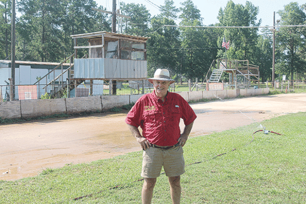 Richard Loveless is pictured as the new sprinkler system waters down the track at Turkey Creek. He is leasing the track from the village on a yearly basis with hopes of expansion. (Gazette photo by Tony Marks)