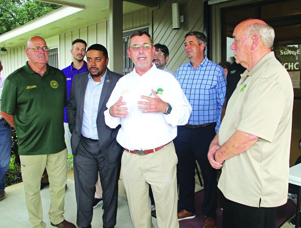 St. Landry Parish President Jessie Bellard explains how $1.5 million in state funding will pay for the Eunice Community Health Center to relocate to a renovated portion of the former Moosa Hospital during a ceremony on Thursday. From left, are Timmy Lejeune, Parish Council member; Chad Andrepont, city alderman; Rep. Dustin Miller; Bellard; Chip Thibodeaux, hospital board chariman; Scott Fontenot, mayor; and Ernest Blanchard, Parish Council member. Parish Council member Jimmie Edwards is behind Blanchard at 
