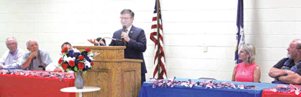 Speaking at lectern is U.S. Rep. Mike Lee at town hall meeting in in Pine Prairie on July 6. Seated, from left, are Evangeline Parish Clerk of Court Randy Deshotel, Evangeline Parish School Board President Wayne Dardeau, Pine Prairie Mayor Quint West, Pastor Kevin West of First Baptist Church Ville Platte, and Pine Prairie Council Members Tammy Buxton and Gilbert Bordelon. (Photo by Tony Marks/Ville Platte Gazette) 