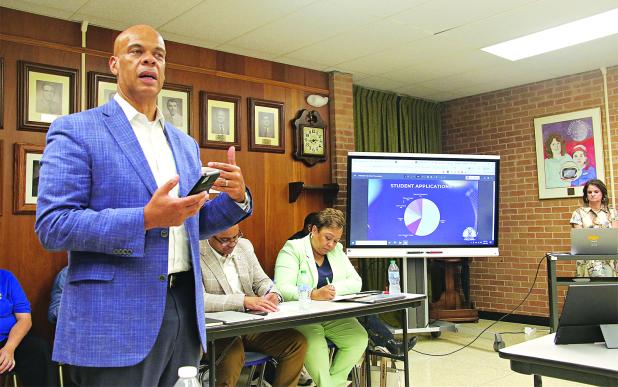  Preston Castille, left, president and CEO at Helix Community Schools, speaks at the St. Landry Parish School Board Committee of the Whole meeting on Tuesday about the opening of new school in Opelousas. (Photo by Harlan Kirgan)