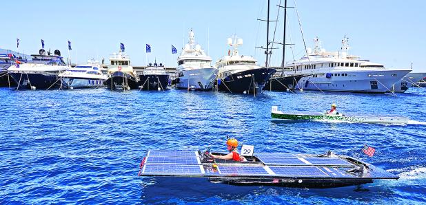 A solar-powered boat designed and built by a team of UL Lafayette mechanical engineering students recently became the first from the U.S. to compete in the Monaco Energy Boat Challenge. The five-member Southern Solar team’s innovative vessel (foreground) was showcased during races, demonstrations and a presentation at the event in Monaco, on the coast of the Mediterranean Sea. (Submitted photo)