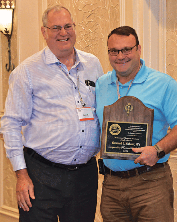Cleveland “Glen” Michaud, right, is presented the Compounding Pharmacist of the Year Award by Darrell Granger. (Submitted photo)