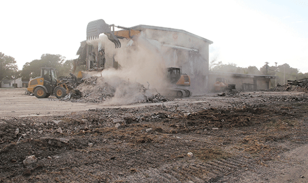 The dust was flying as heavy equipment worked on the demolition of the old Moosa Memorial Hospital on Tuesday afternoon. By Thursday, the central two-story portion of the building was left standing alone. Another portion of the structure remained on the north side. St. Landry Parish Government crews are doing the demolition. (Photo by Harlan Kirgan)