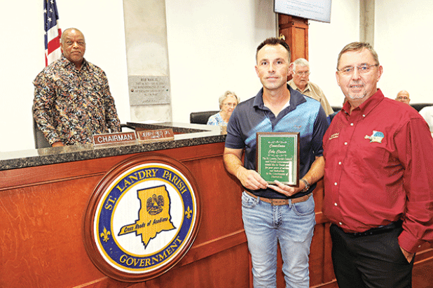 Former St. Landry Parish Council member representing District 13 Coby Clavier holds a plaque recognizing his service at Wednesday’s Parish Council meeting. From left, are Jerry Red, Council chairman; Vivian Olivier, Council member; Clavier; Wayne Ardoin, Council member; Jessie Bellard, parish president; and Timmy Lejeune, Council member. Clavier was elected to two terms, but resigned recently citing conflicts with his job. (Photo by Harlan Kirgan)