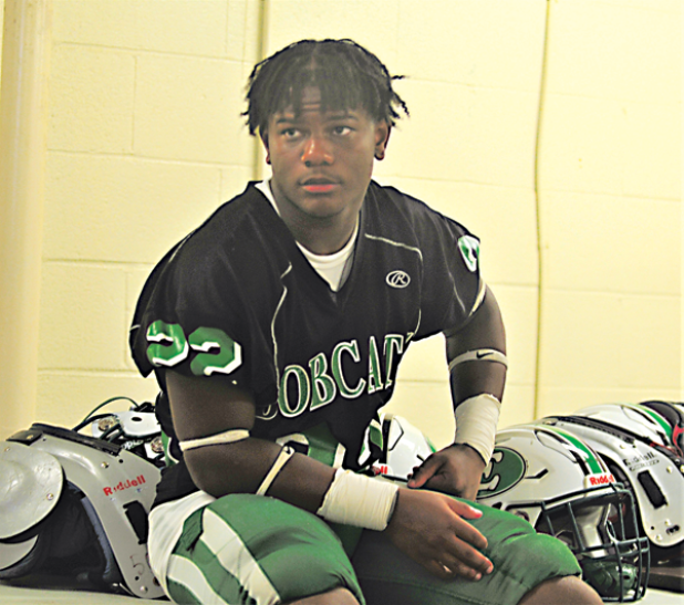Eunice High’s Lathan Kennedy sits in the locker room as it storms outside at Clark Field in Lafayette. (Photo by Tom Dodge) 