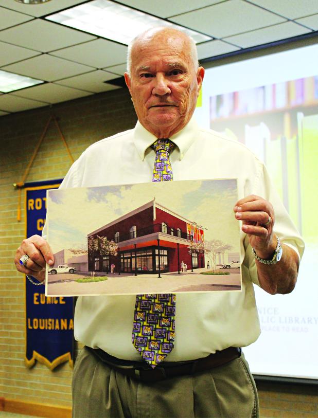 Tony Baltakis holds up an artist’s rendition of the future Eunice Public Library. He was the guest speaker Wednesday at the Rotary Club meeting. (Photo by Myra Miller) 
