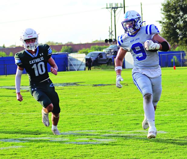 Max Smith, a sophomore tight end, evades a Catholic Pointe Coupee defender in the joe Nagata Jamboree. (Photos by Amy Myers)