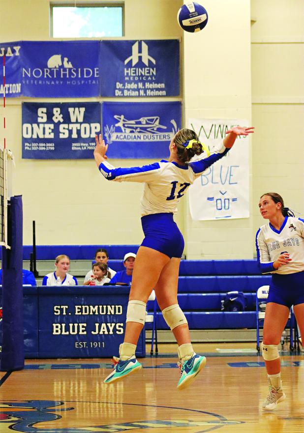 St. Edmund’s Laura Kate Miller (12) jumps to action as Caroline Lavergne looks on in the match with Westminster Christian Academy Lafayette on Sept. 2.(Photo by Amy Myers)