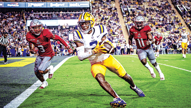 LSU’s junior receiver Kyren Lacy rushes toward the end zone as Nicholls players Laurence Sullivan Jr., No. 3, and Quinton Sharkey, No. 11, pursue in Saturday’s game in Tiger Stadium. LSU won 44-21. (Photos by Dwight Jodon)