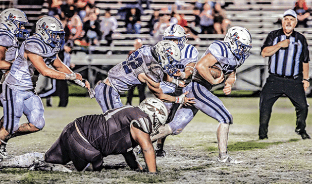 Blue Jay running back Henry Summerlin races through the Elton defense on the way to a 45-15 victory on a muddy field. (Photo by Dwight Jodon)