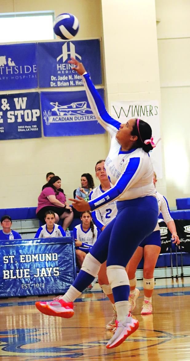 St. Edmund’s Reagan Gradney spikes the ball over the net in a match with DeQuincy. St. Edmund won all three sets 25-16, 25-21, 25-10. (Photo by Amy Myers)