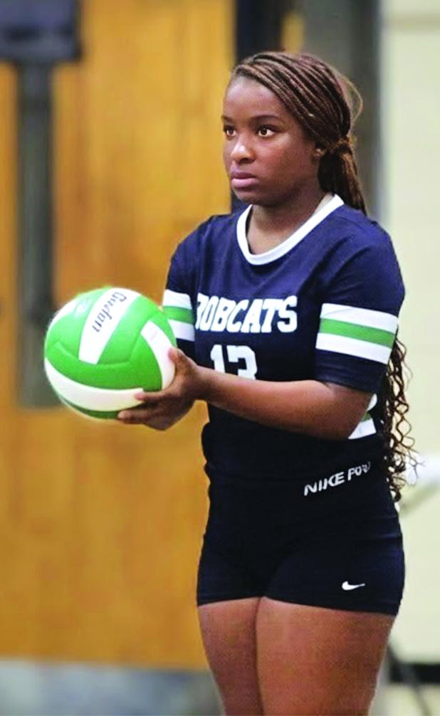 Junior Cayli Lemelle sets and serves the ball. (Photo by Rhett Manuel)