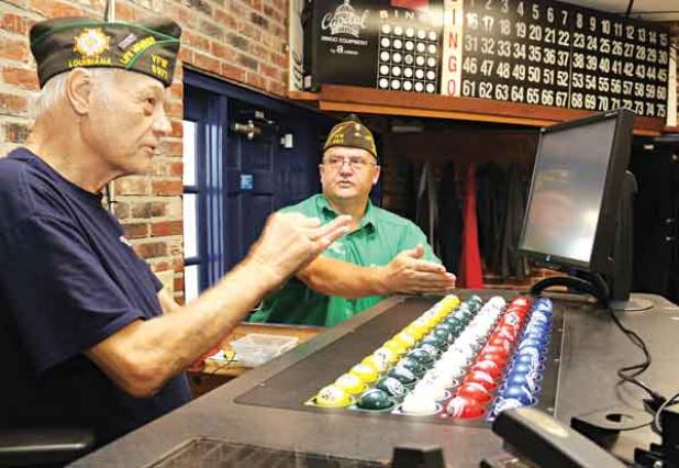 The progressive jackpot at the VFW Post 8971 bingo has reached $10,000. Bingo games are held on Thursdays and Sundays. Explaining the game, from left, are Donald Estillette, post chaplain, and Donnie Fontenot, post commander. (Photo by Harlan Kirgan)