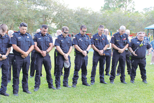 In prayer are first responders during Sunday evening’s 911 ceremony.