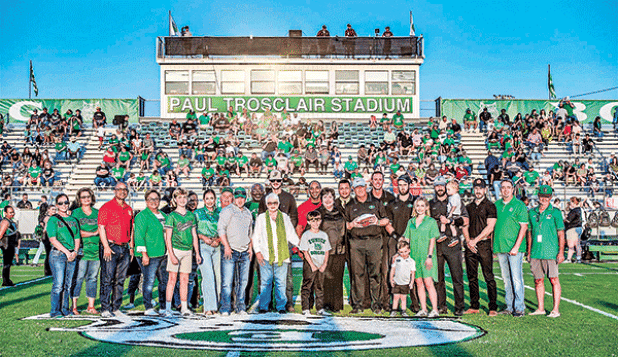 Paul Trosclair, holding a football near the center of photo, was honored at the Sept. 13 football game when the Eunice High School stadium officially was named the Paul Trosclair Stadium. During his career at Eunice High Trosclair has served as athletic director, head football coach and mentor. (Photo by Dwight Jodon)