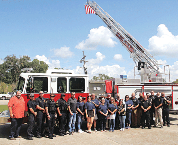 Ardoin’s Funeral Home of Eunice treated first responders to a barbecued pork steak meal on Wednesday in remembrance of the Sept. 11, 2001, response to the terrorist attack on the United States. Some of the Eunice first responders are by a fire truck flying the United States flag at noon. Volunteers served 169 lunches on Wednesday. Ardoin’s has been doing the remembrance since 2002 This year’s event was delayed a week because Hurricane Francine made landfall on Sept. 11. (Photo by Harlan Kirgan)