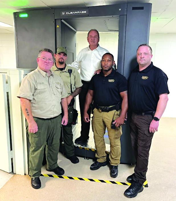 With the full body security scanner at the St. Landry Parish Jail are, from left, Deputy Chief Eddie Thibodeaux, Lt. Brody Istre, Sheriff Bobby Guidroz, Warden Adam Ford and Assistant Warden Nicholas Sheumaker. (Submitted photo)