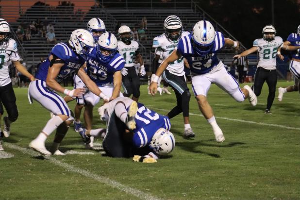 St. Edmund Blue Jay Lannie Reed tackles a Morgan City Tiger player during Friday’s football game played at St. Ed’s home field. (Photo by Amy Myers)