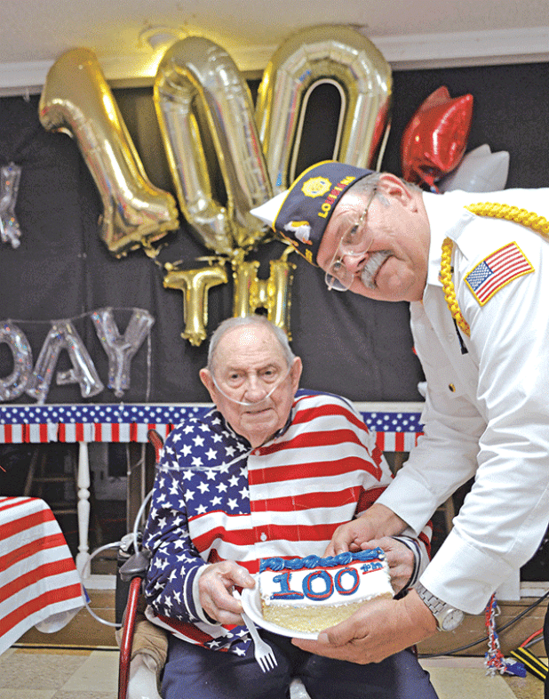 World War II and U.S. Navy Veteran Joe Richard of Church Point is presented with a slice of birthday cake by American Legion Post 225 Commander Dennis Hart during Richard’s 100th birthday party on July 23. Richard, Louisiana’s last known Pearl Harbor survivor, according to the Louisiana Department of Veterans Affairs, passed away Wednesday, just two months after his 100th birthday. (Photo by Claudette Olivier/Church Point News)
