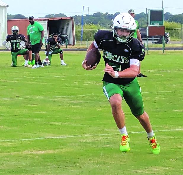 Senior quarterback Montana Brown scrambles for yardage. (Photo by Rhett Manuel)