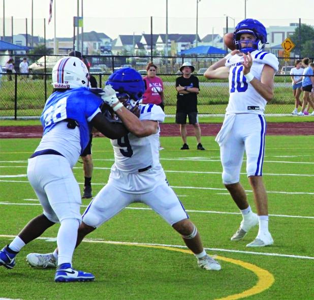 Senior quarterback Nathan Zaunbrecher fires a pass during live action. (Photo by Rhett Manuel)