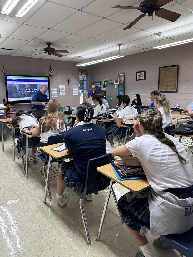 Chad Jones, institutional liaison officer and Van Reed, administrator with St. Landry Parish government who worked at Louisiana State University Eunice for almost 14 years and St. Edmund  for 14 years, visited with St. Edmund High seniors. 