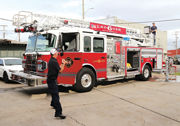 Eunice Fire Chief Mike Arnold, left, and firefighter Robert Avery work with the department’s new 75-foot ladder truck behind the Central Fire Station. (Photos by Harlan Kirgan)