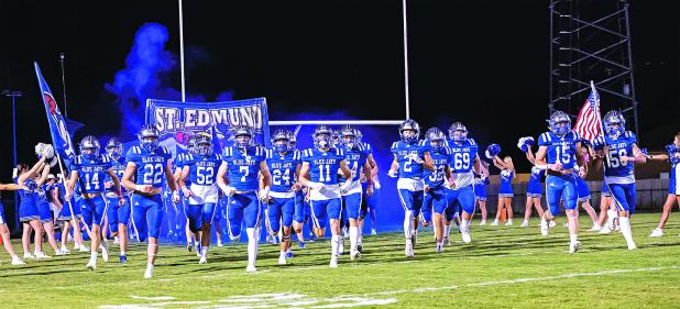 The St. Edmund High School football team takes the field for their homecoming game with Berchmans Academy on Oct. 11. (Photo by Dwight Jodon)
