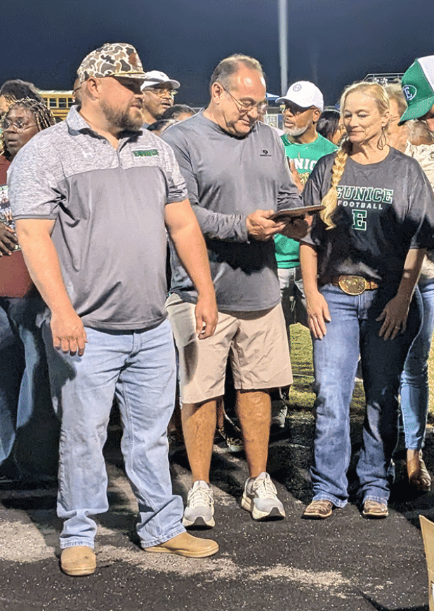 Marion Fruge holds a plaque he was presented at the Oct. 11, 2024 Eunice High School football game. The plaque noted him being named to the Eunice High Athletic Hall of Fame. (Photo by Rhett Manuel)