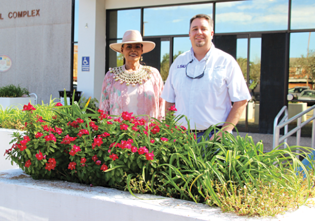 Angelia Guillory, community service supervisor, and Mayor Scott Fontenot by a flower box in front of the Eunice Municipal Complex. (Photo by Myra Miller)