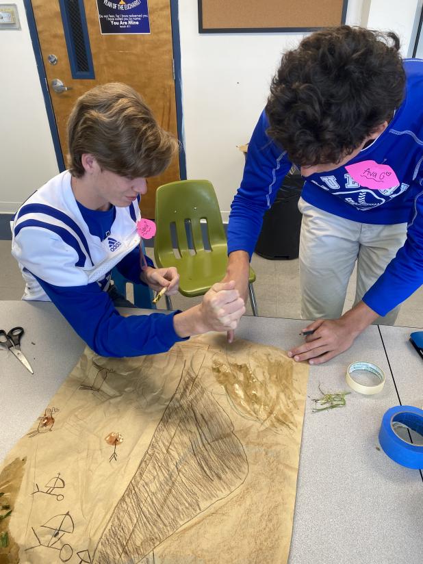 Allison Reed’s Fine Arts Survey students at St. Edmund High collaborated to create original works of art that imitate Paleolithic cave paintings using a combination of art materials and a variety of natural pigments, like mud, fruit, grass, and coffee bean.