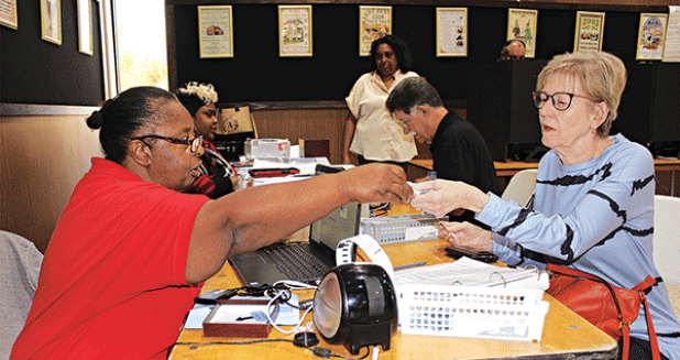 Candice Soileau of Eunice, at right, is getting ready to early vote at Eunice City Hall. Assisting her is Commissioner Cheryl Martin. 