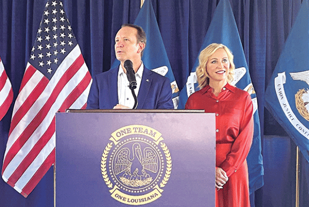 Gov.-elect Jeff Landry and his wife, Sharon, address reporters Oct. 25, 2023, at M.L. “Tigue” Moore Field at the University of Louisiana in Lafayette. (Piper Hutchinson/Louisiana Illuminator)