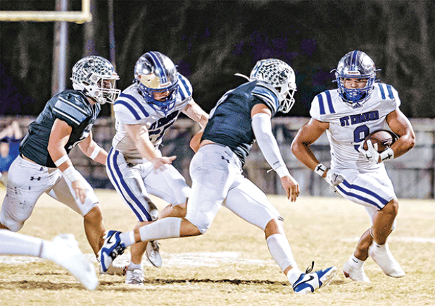 St. Edmund’s Marcus Gradney works to avoid a Catholic-Pointe Coupee pursuit in the 26-22 loss on Oct. 24. (Photo by Dwight Jodon)