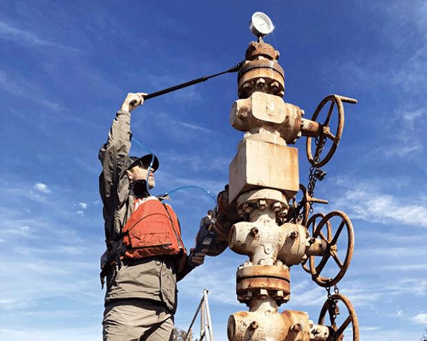 A U.S. Fish and Wildlife Service worker tests an abandoned well in Lacassine National Wildlife Refuge near Lake Charles. (USFWS photo) 